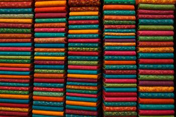 Stacks of colourful textiles in a cloth bazaar
