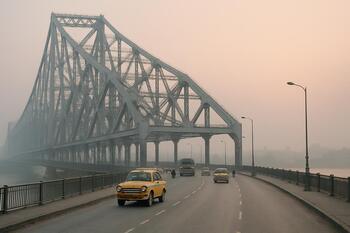 Howrah Bridge in a pale morning with slow traffic